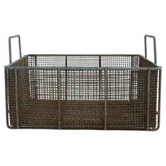 a large metal basket with two handles on the front and back sides, in brown color