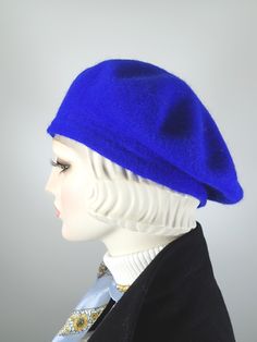 This women's warm and cozy gorgeous one of a kind royal blue French Beret Tam is a classic piece that never goes out of style. It's made of 100% wool that has been felted, creating a warm winter hat that keeps the cold air at bay. The color is a gorgeous, deep royal blue color. It is embellished with a handmade rosette made from hand dyed silk ribbon, vintage velvet leaves, vintage netting and vintage rhinestone buttons. One of a kind, unique and beautiful! ++++++++++++++++++++++++++++++++++++++ Blue Formal Winter Hat, Formal Blue Winter Hat, Blue Flat Cap For Fall, Classic Fitted Blue Hat, Fitted Blue Flat Cap, Blue Wool Cap, Classic Blue Winter Hat, Classic Cloche Cap, Classic Blue Felt Hat With Short Brim