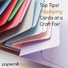 a pile of different colored cards with the words top tips displaying cards at a craft fair