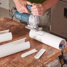 a person using a power tool to cut plastic pipes