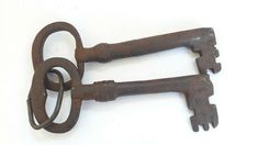 two old rusty keys on a white background