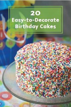 a birthday cake with sprinkles sitting on top of a glass platter