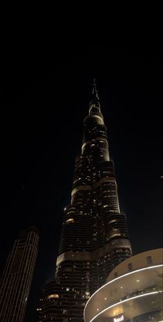 the burj building is lit up at night