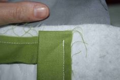 someone is stitching the edge of a piece of fabric