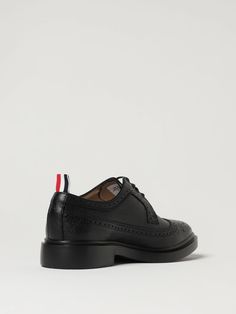 Classic Design  Grained Calfskin  Laceup  Round Tip  Dovetail Brogue Pattern  Waxed Cotton Laces  Reinforced Heel  Fabric Logo Flag Tie  Smooth Leather Interior  Logo Inlaid On The Insole  Rubber Sole Thom Browne Shoes, Black Brogues, Brogues Men, Interior Logo, Brogue Shoes, Leather Dress Shoes, Derby Shoes, Waxed Cotton, Thom Browne