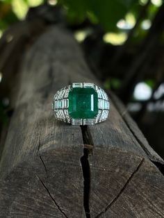 The 5.47 Carat Emerald has a gorgeous, vivid green color, and has been cut to perfection to form this beautiful Emerald Cut piece you see. The color is so beautifully rich and elegant, it just fits right into the setting and catches everyone's eye from all the way across the room. Yes, you read that right! It's a 5.47 Carat piece that you're getting at this price!! The eye-catching Emerald centerpiece along with diamonds on the band bring out an amazing overall look of the ring. A simple, stunni Luxury Green Octagon Rings, Luxury Green Emerald Ring With Diamond Cut, Formal Green Emerald Ring With Polished Finish, Classic Green Emerald Ring With Baguette Diamonds, Luxury Rectangular Emerald Ring, Luxury Green Baguette Cut Emerald Ring, Luxury Green Emerald Ring With Polished Finish, Luxury Green Emerald Ring With Vvs Clarity, Luxury Green Emerald Diamond Ring