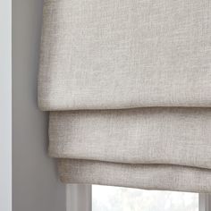 a close up view of a roman blind with the blinds pulled back to allow privacy