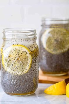 two mason jars filled with chia seeds and lemons