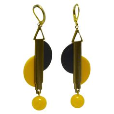 Beautiful piece of jewellery are these modernist pair of drop earrings. As one of the leading manufacturers of jewellery the European Art Deco produced in the 20's and 30's very innovative and individual pieces of jewellery, aesthetically characterised by the modernist designs. These earrings are made from Black and yellow Bakelite, with gold tone metal work ribbed to the centre. Very much in the style of Jakob Bengel. The mildest of tarnishing otherwise excellent condition. All our Jewellery and watches are sent out in complimentary gift boxes first class international delivery 2-3 days. Art Deco Drop Earrings, White Gold Drop Earrings, Jewellery Inspiration, Yellow Art, 1920s Art Deco, 1930s Art Deco, Modern Art Deco, Estilo Art Deco, Ancient Jewelry