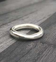 This Chunky Wave Ring is made from Sterling Silver. This freeform ring is a statement piece. The chunky, slightly wavy rounded shank is completely handmade, not cast.  The ring measures approx: 5mm in width. Please let me know the ring size you require at Checkout and whether you used a narrow ring sizer (approx: 4mm in width) or a wide ring sizer (approx: 6mm in width). This ensures a perfect fit. Wave Ring Silver, Thick Silver Ring, Freeform Ring, Unusual Wedding Rings, Chunky Silver Rings, Chunky Ring, Wave Ring, Wide Ring, Chunky Rings