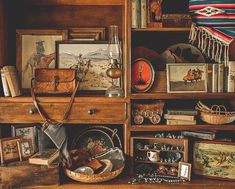 an old wooden shelf filled with assorted items