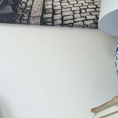 a blue and white vase sitting on top of a table