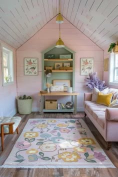 a living room with pink walls and wood flooring on the ceiling is decorated in pastel colors