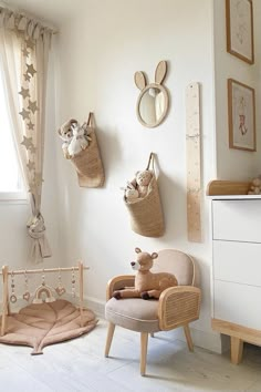 a baby's room with white walls and wooden furniture