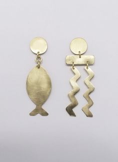 Discover a stunning pair of handcrafted brass earrings that are truly one-of-a-kind. With a touch of the Aegean Sea, these earrings are skillfully cut, textured and polished to perfection. What sets them apart is that they are made without any harmful chemicals or varnishes. The metals are processed using only natural methods, which means you can enjoy the beauty of these earrings with a clear conscience. If you appreciate beautiful and unique earrings, these are definitely worth considering. Se Elegant Gold Fish-shaped Earrings, Gold Fish-shaped Earrings, Gold Fish-shaped Pierced Earrings, Clear Conscience, Wire Crochet, Tourmaline Bracelet, Aegean Sea, Mismatched Earrings, Gold Cuffs