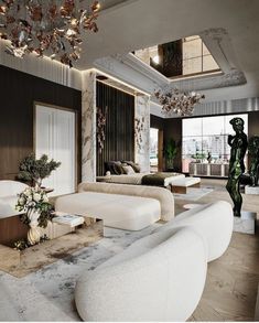 a living room with white couches and chandelier hanging from it's ceiling