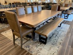 a dining room table with benches and chairs in the center, along with other tables