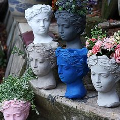 several vases with flowers in them sitting on some steps