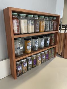 a wooden spice rack filled with lots of different types of spices