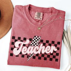 Checkered Teacher Shirt, Retro Teacher Shirt, Retro Teacher Tee, Comfort Colors® Teach Shirt, Cute Back to School Teacher Shirt, Teach Shirt PRODUCTION TIME: 1-5 days (Typically 2 days) A little longer during the holiday season. SHIPPING TIME: 2-5 days (Typically 3 days) A little longer during the holiday season. PRODUCT DESCRIPTION: Comfort Colors is a garment-dyed t-shirt. A fully customizable tee made 100% with ring-spun cotton. The soft-washed garment-dyed fabric brings extra cosiness to you Teach Shirt, Teaching Shirts, Teacher Tees, Dyed Fabric, School Teacher, Teacher Shirts, Dye T Shirt, Comfort Colors, San Jose