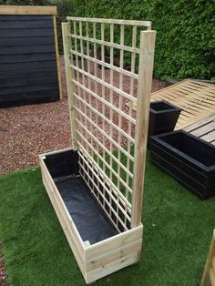 a wooden planter sitting on top of a lush green field