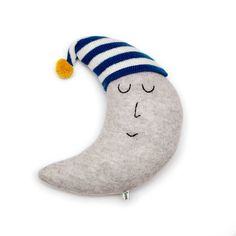 a stuffed moon with a blue and white striped hat