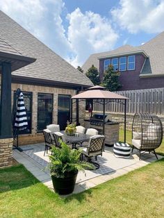 a patio with chairs and an umbrella on it