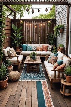 an outdoor living area with couches, tables and potted plants on the deck