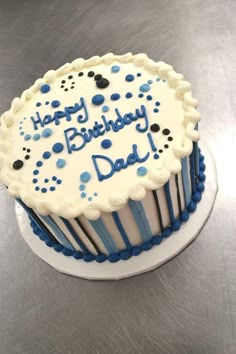 a blue and white birthday cake with the words happy birthday dad on it's frosting