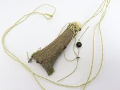 Natural tree bark necklace. Osage Orange (Hedge) bark, peeled from a coppicing tree, which is a fresh shoot from a previously cut tree.  It is folded and rolled, with a natural twig "cork."  Then woven around the top, so the "cork" doesn't come out.  Stitching is pale, spring green. There is a small amount of preserved bright green moss stuck in at the bottom!  A few glass and stone beads for sparkle. It is stiff, as it is bark. If you wear it and hug someone hard, you might crush it!   approx. Crush It, Tree Jewelry, Natural Tree, Small Necklace, Medicine Bag, Amulet Necklace, Green Tree, Jewelry Tree, Tree Bark