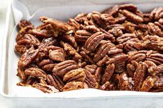 pecans in a white dish on a table