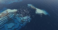 an aerial view of the ocean with blue and white blocks floating on it's surface