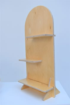 a wooden shelf with two shelves on each side and one shelf attached to the back