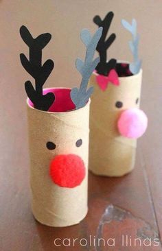 two toilet paper cups decorated with reindeer noses and antlers