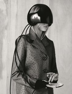 a woman in a coat and helmet holding a cell phone