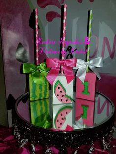 there is a cake made to look like watermelon blocks with bows on it