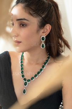 This elegant necklace set is encrusted with stunning emerald green stones and adorned with sparkling white zirconia. The statement faux diamond necklace is paired with matching earrings, making it the perfect accessory for any formal occasion. Make a bold and sophisticated statement with this luxurious set. Necklace Closure - Adjustable Dori, 107gm Earrings Closure - Push Back, 26gm (pair) Emerald And Diamond Necklace, Green Emerald Necklace, Emerald Green Necklace, Emerald Green Stone, Contemporary Necklace, Chic Necklace, Diamond Necklace Set, Emerald Necklace, Kundan Jewellery