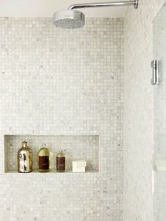 a bath room with a toilet a sink and a shower head mounted to the wall