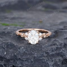 an engagement ring on top of a rock