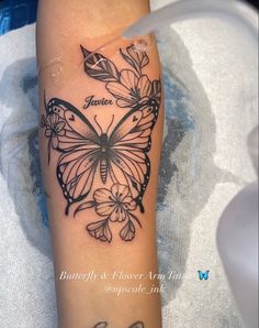 a black and white butterfly tattoo on the leg