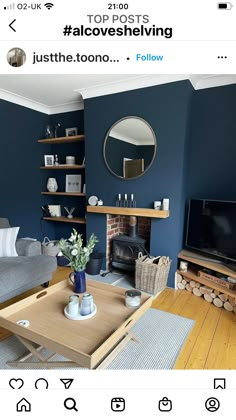 a living room with blue walls and wooden floors is featured in the instagram post