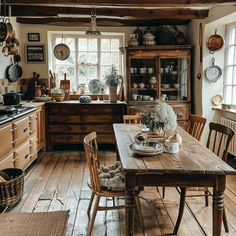 an old fashioned kitchen with wooden floors and cabinets