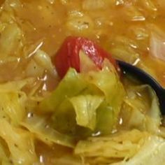 a spoon full of soup with noodles and vegetables