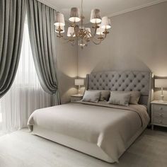 a bedroom with a bed, chandelier and two lamps on either side of the bed