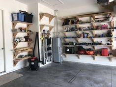 a garage filled with lots of shelves and tools on the wall next to a refrigerator