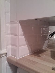 a kitchen counter top with a plastic container on it's side and a knife sticking out of the bottom