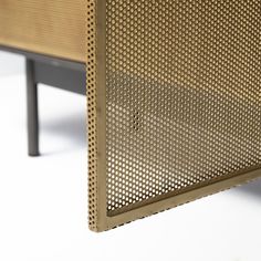 the back side of a bench with perfored metal mesh covering it's sides