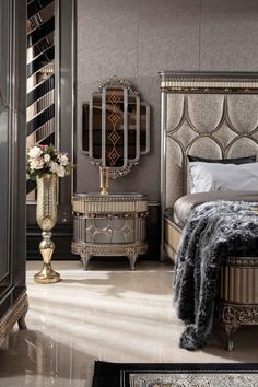 a bedroom with a bed, dresser and mirror on the wall next to each other