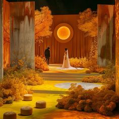 a bride and groom are standing in the middle of an outdoor garden with yellow foliage