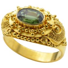 Intricate detail and spirals swirl around this deep green faceted tourmaline ring. Set in high carat 22K yellow gold this ring makes a statement fit for the Maharaja. Royal, regal and bright, the yellow gold glows in classical Indian fashion with the illuminating grassy green tourmaline ( aprox 1.0 ct). The wind-up piano box plays music and the lid to the keys lifts up uncovering the tiny golden keyboard. The ring size is 6.75 and can be sized to fit your finger. Kemp Ring, Gold Ring Images, Thick Gold Ring, Haute Jewelry, Indian Rings, Jewelry Piercing, Contemporary Jewelry Design, Pink Sapphire Ring, Gold Cocktail Ring